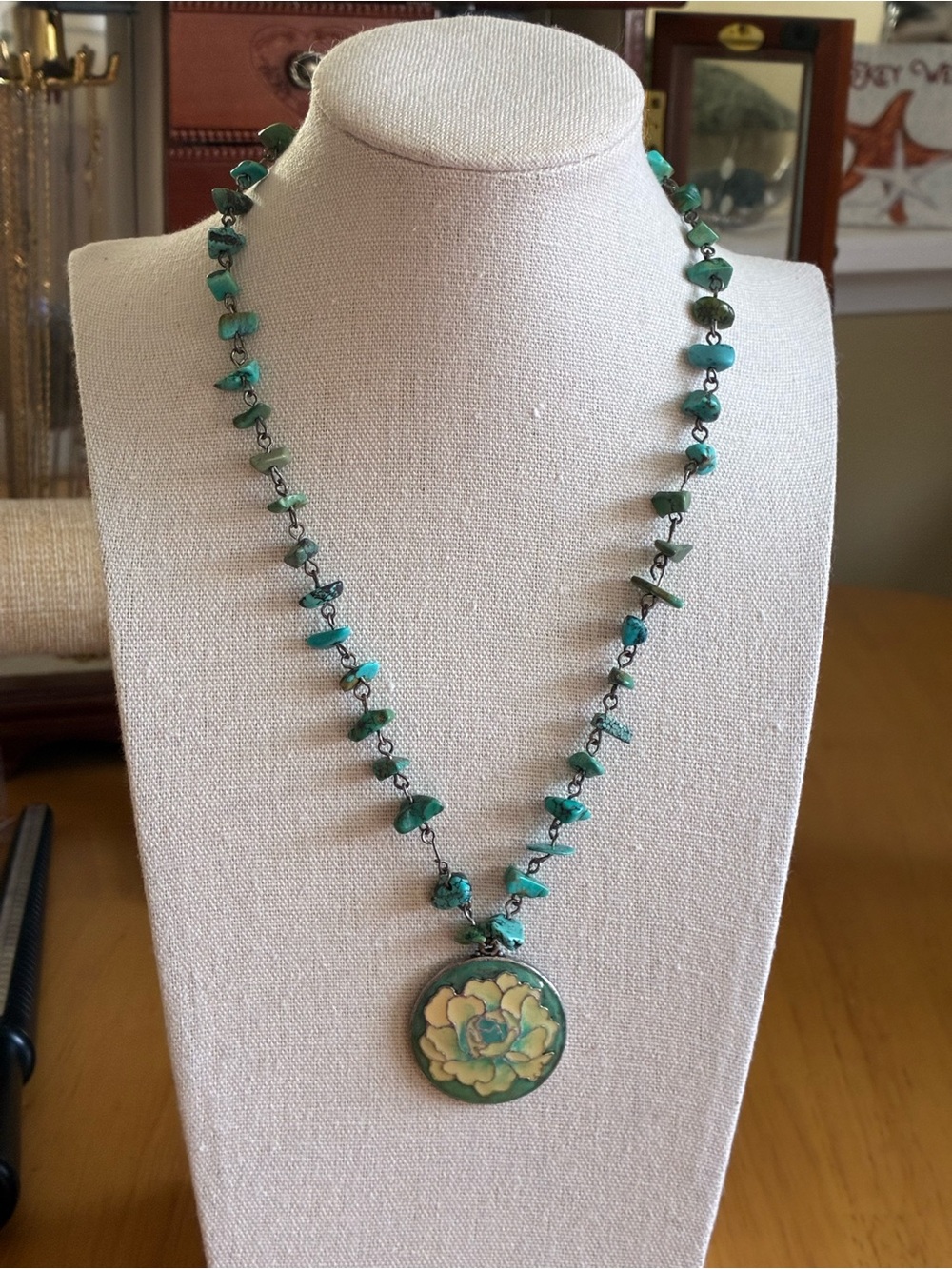 Vintage style turquoise chip beaded necklace with enamel floral pendant.